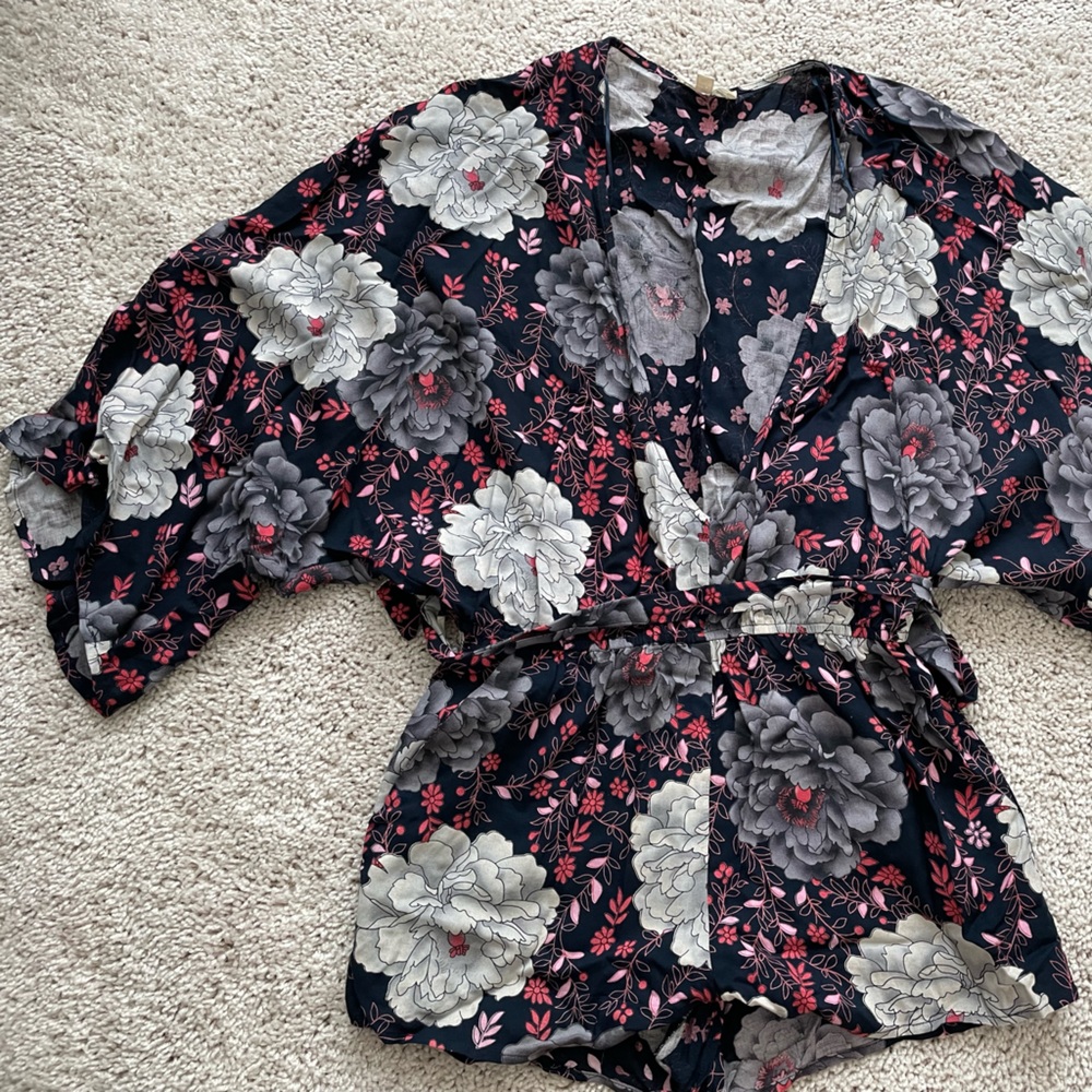 Short flows sleeve, low v neck romper with floral design. S